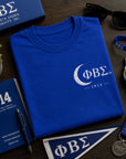 Phi Beta Sigma 1914 t-shirt displayed with fraternity accessories and professional lifestyle items