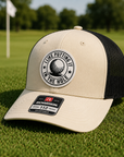 Birch and black trucker golf hat with tan front panel and circular 'I Like Putting' patch