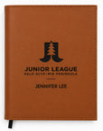 Brown notebook with 'Junior League' logo and text on a white background
