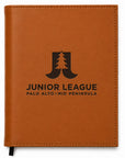 Brown leather notebook with Junior League logo and text on a white background