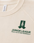 Close-up of green chest logo on natural raglan sweatshirt
