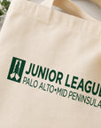 Natural tote bag with 'Junior League Palo Alto Mid Peninsula' logo on a light background