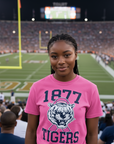 Black woman wearing a pink Jackson State University Roar For Thee Cure T-Shirt at a football stadium