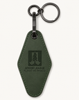 Junior League Palo Alto Mid Peninsula green laser engraved motel keychain with black gunmetal hardware on a clean neutral background