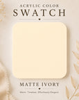 Acrylic color swatch labeled 'Matte Ivory' on a beige background with decorative elements.