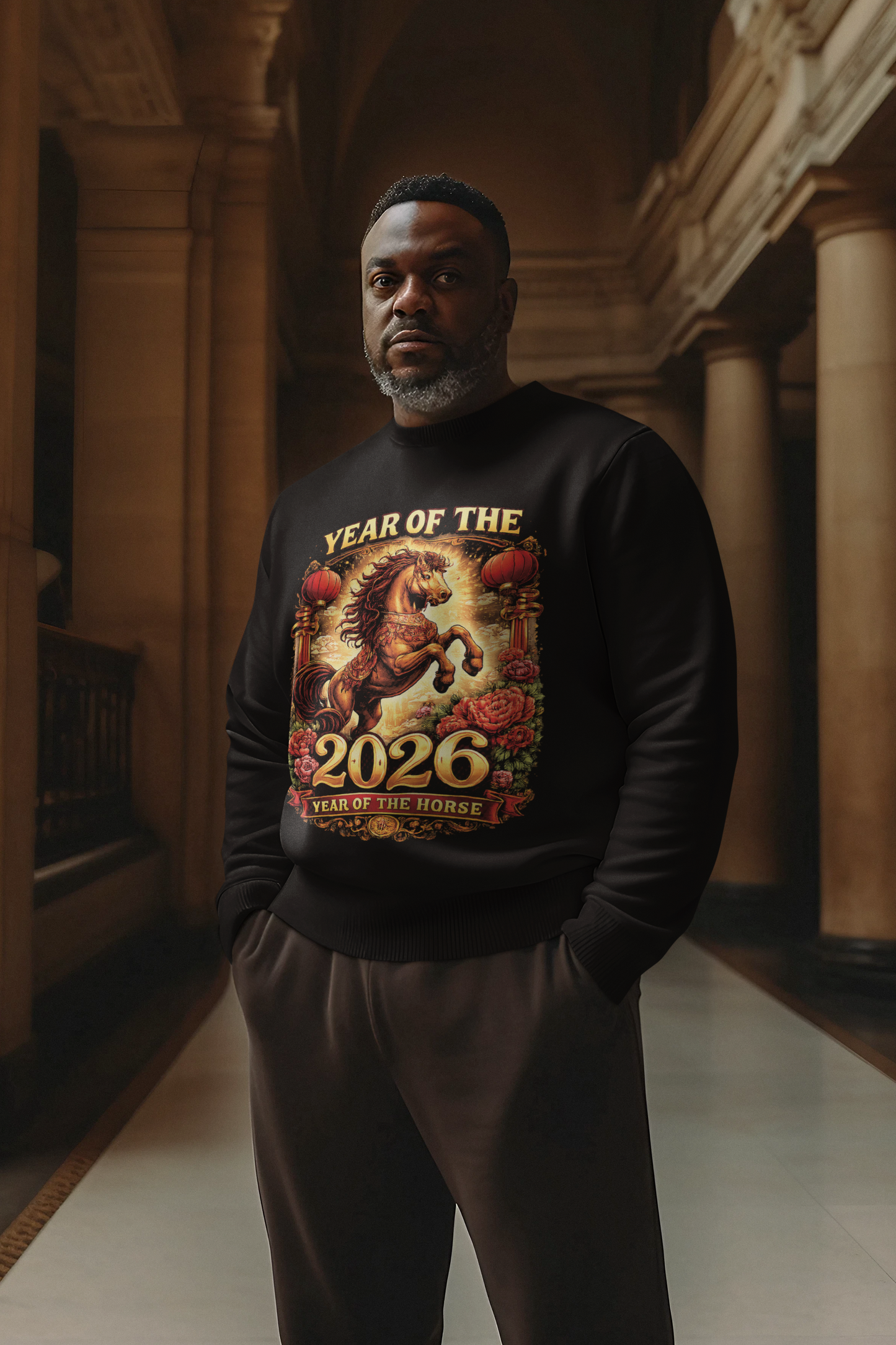 Man wearing a black sweatshirt with 'Year of the Horse 2026' design in an indoor setting.