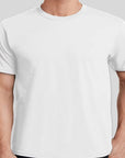 White t-shirt worn by a person on a light gray background