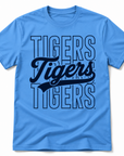 A light blue short-sleeve crewneck t-shirt featuring a large 'Tigers' graphic on the front, with 'TIGERS' in outlined block letters and 'Tigers' in a dark navy script font in the center.
