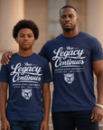 Two people wearing 'The Legacy Continues' t-shirts in front of a building.