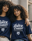 Two women wearing navy blue t-shirts with 'The Legacy Continues' text, standing on steps outdoors.
