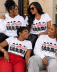Four Black women wearing Just A Diva from Delta Pi white apparel in an editorial lifestyle setting