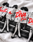 Close-up detail of Just A Diva from Delta Pi newspaper halftone and red print on white apparel