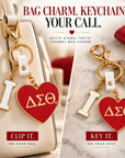 Delta Sigma Theta I Heart DST charm shown clipped to a handbag and used as a keychain