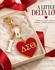 Delta Sigma Theta I Heart DST enamel bag charm presented as a Soror gift with cream packaging and crimson ribbon