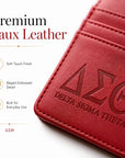 Close-up of the premium faux leather texture, stitching, and embossed Delta Sigma Theta Greek letters on the slim wallet.