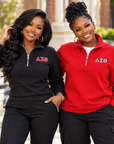 Two Black women modeling black and red Delta Sigma Theta quarter-zip sweatshirts
