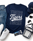 Jackson State game day outfit featuring the Tigers Stacked Script T-Shirt with jeans, sneakers, cap, stadium bag, and accessories