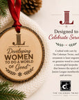 Junior League natural wood slice ornament with red ribbon and Developing Women engraving