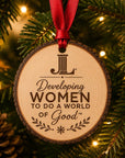 Junior League natural wood slice ornament centered on tree lights with red ribbon