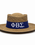 A natural woven straw fedora hat with a wide brim and a dark blue band featuring the Greek letters Phi Beta Sigma in white.