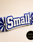 Small personalized acrylic name spirit stick from the Classic Collection featuring white, royal blue, and white three-layer acrylic with coordinating royal blue and white pom-poms, available up to 10 inches.