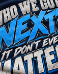 Close-up of distressed blue gray and white Who We Got Next It Don't Even Matter print on navy fabric
