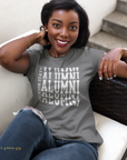 Gray crew-neck short sleeve T-shirt with white stacked “Alumni” graphic on model