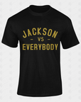 Black crewneck short sleeve T-shirt with centered gold “JACKSON vs EVERYBODY” graphic.
