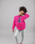 Pink youth pullover hoodie with J Tigers logo on chest, worn by a child