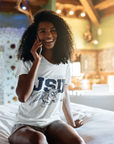 White V-neck T-shirt with JSU lettering and leaping tiger graphic, close-up on model