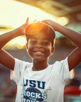 Youth T-shirt with blue "JSU Rocks the House" front print on child