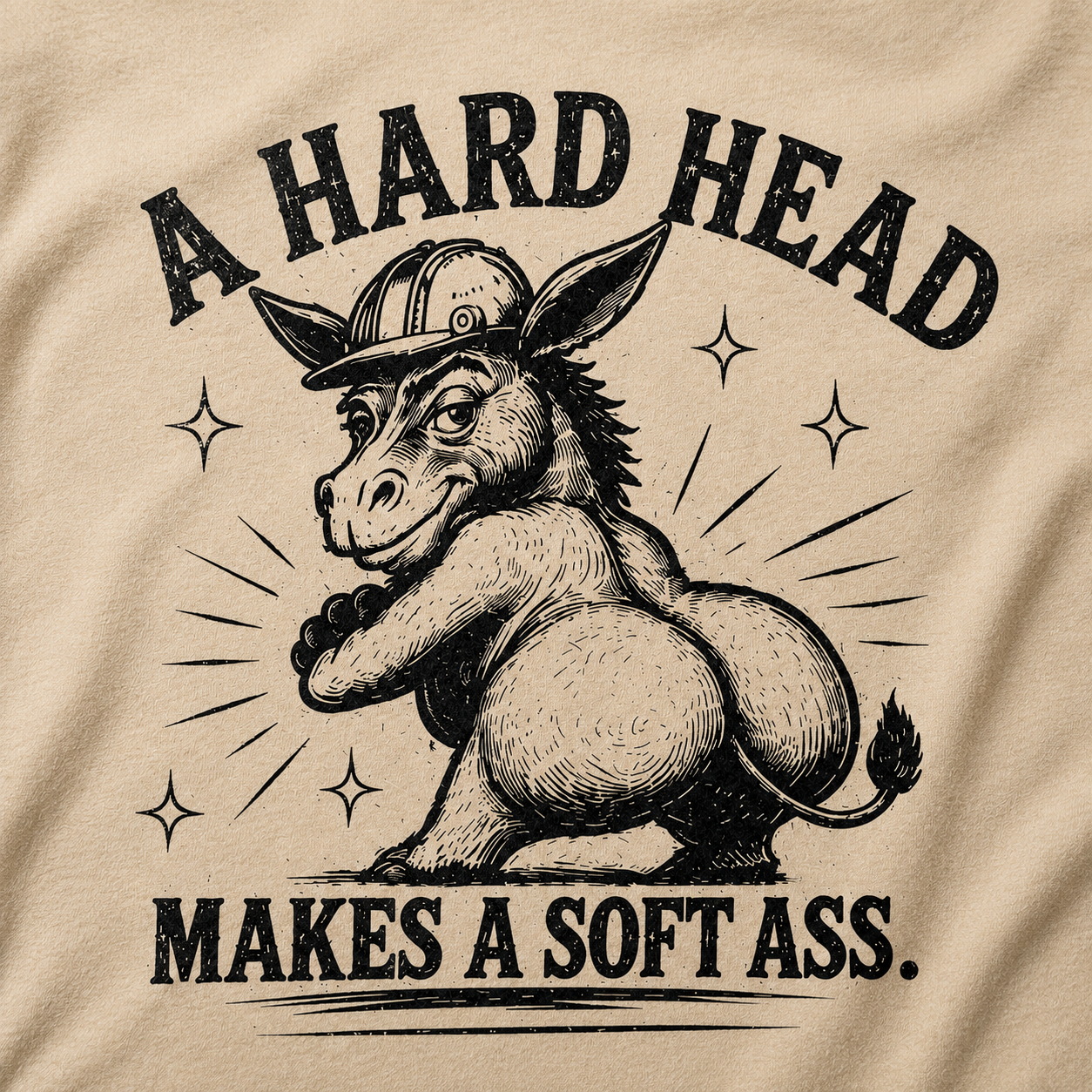 Close-up detail of distressed western donkey graphic printed on sand colored t-shirt