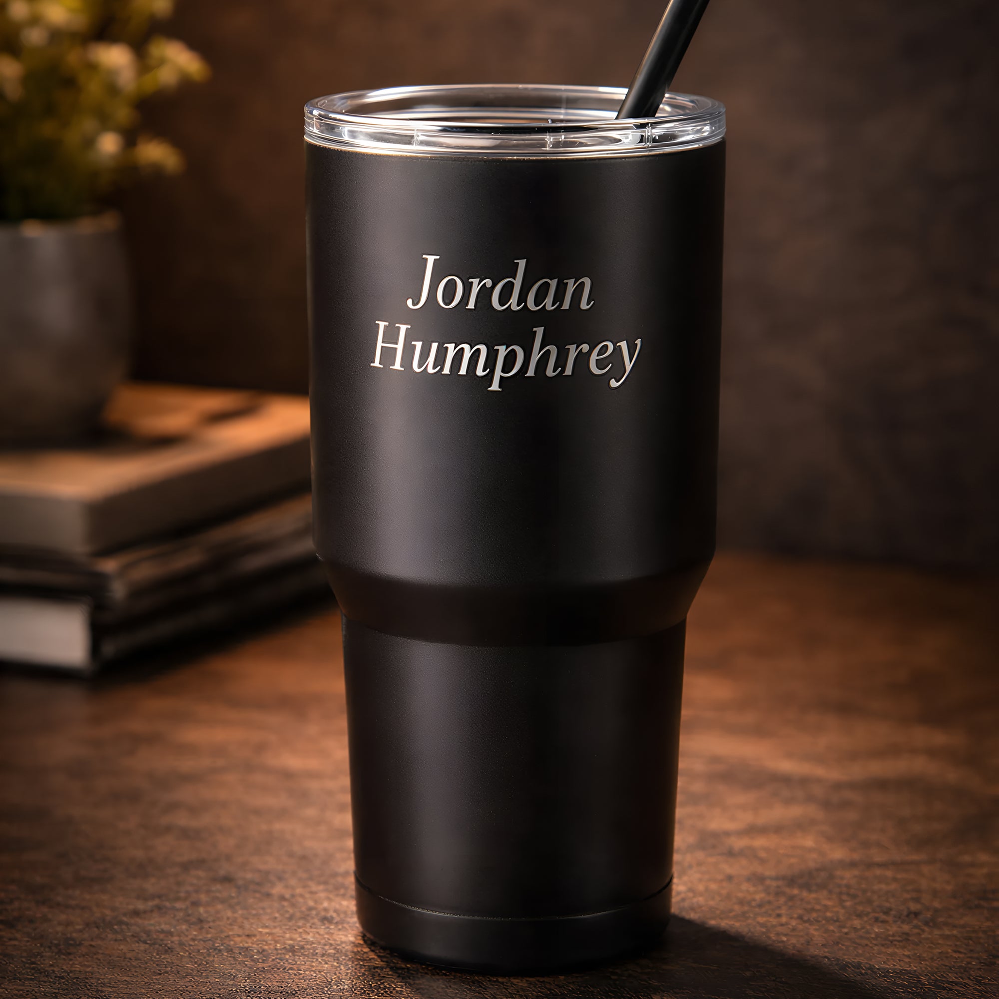Black tumbler with silver name engraving — clean lifestyle background