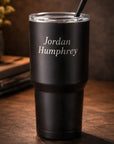 Black tumbler with silver name engraving — clean lifestyle background