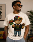 White T-shirt with teddy bear graphic wearing a Juneteenth 1865 hat and sneakers