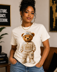 White T-shirt with teddy bear graphic wearing a hoodie with Juneteenth 1865 emblem