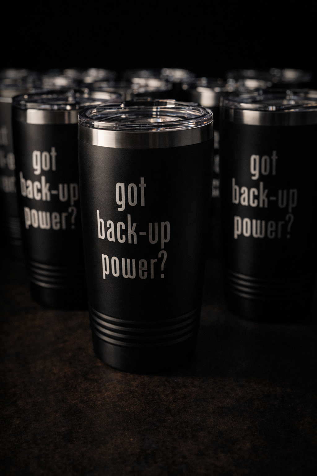 Black tumblers with 'got back-up power?' text on a dark background