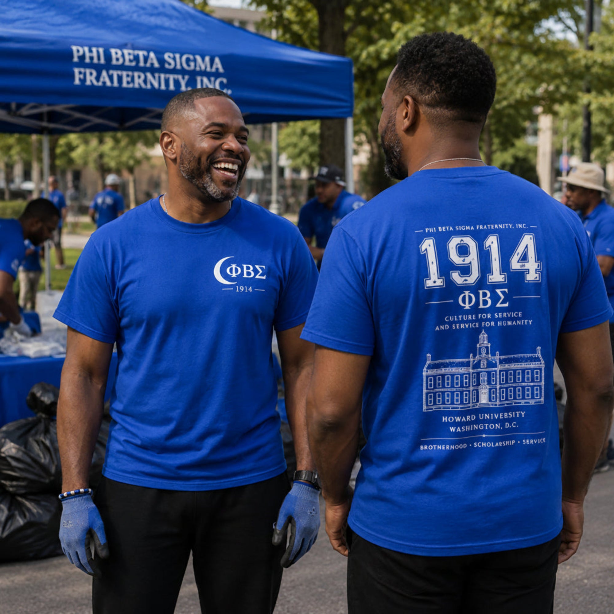 Two Phi Beta Sigma brothers wearing 1914 fraternity shirts after community service event showing front and back designs