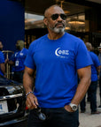 Phi Beta Sigma 1914 t-shirt worn by Black professional man outside luxury hotel during fraternity conference weekend