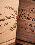 Two wooden plaques with engraved family names and establishment years.