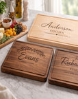 Three wooden cutting boards with engraved names on a marble surface.