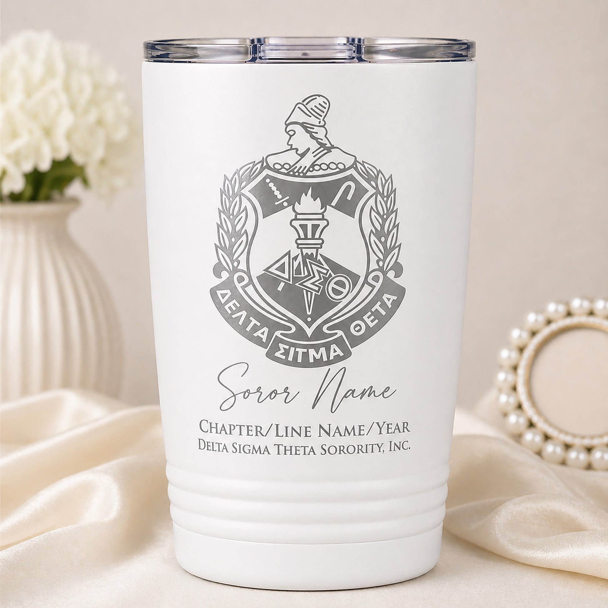White tumbler with Delta Sigma Theta sorority emblem and personalized text on a neutral background.