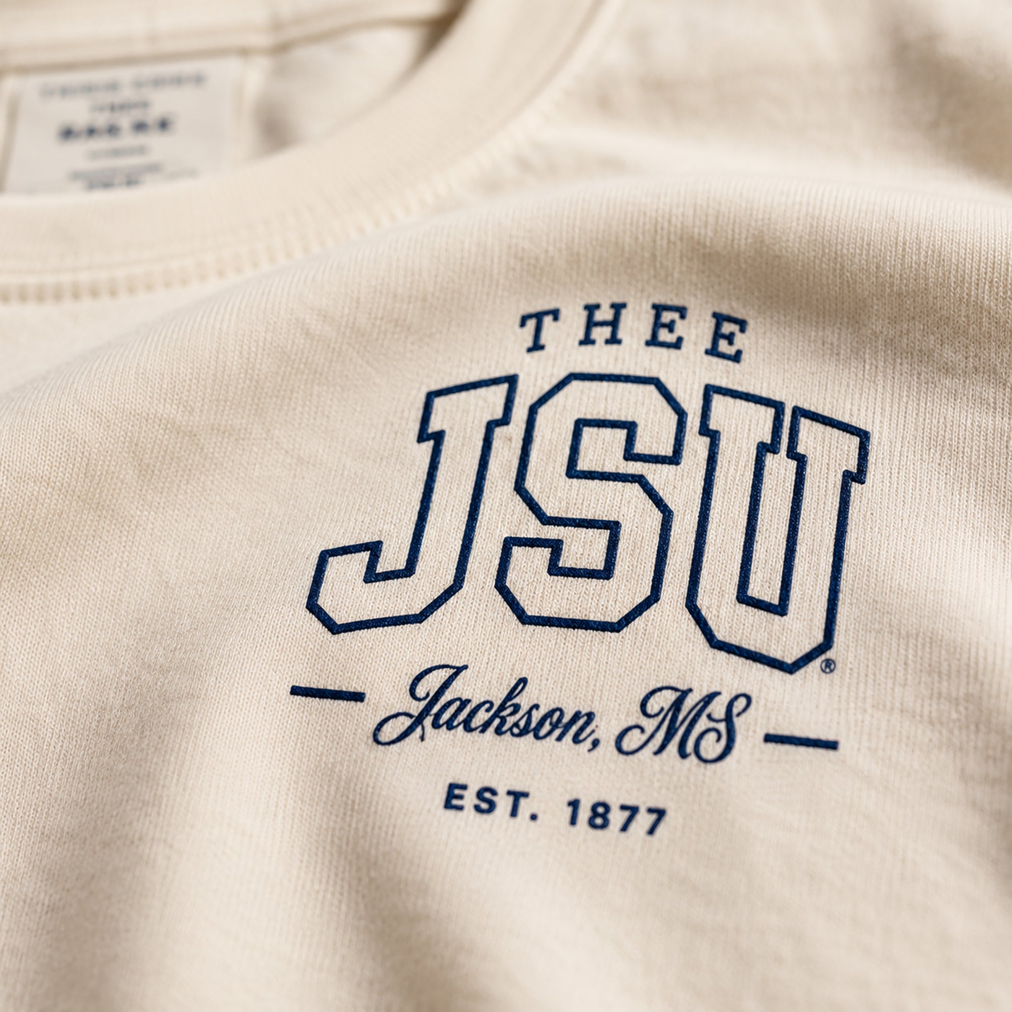 Beige sweatshirt with 'THEE JSU Jackson, MS EST. 1877' text in navy