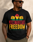 Black Juneteenth graphic T-shirt with raised fist icons and “JUNETEENTH FREEDOM”