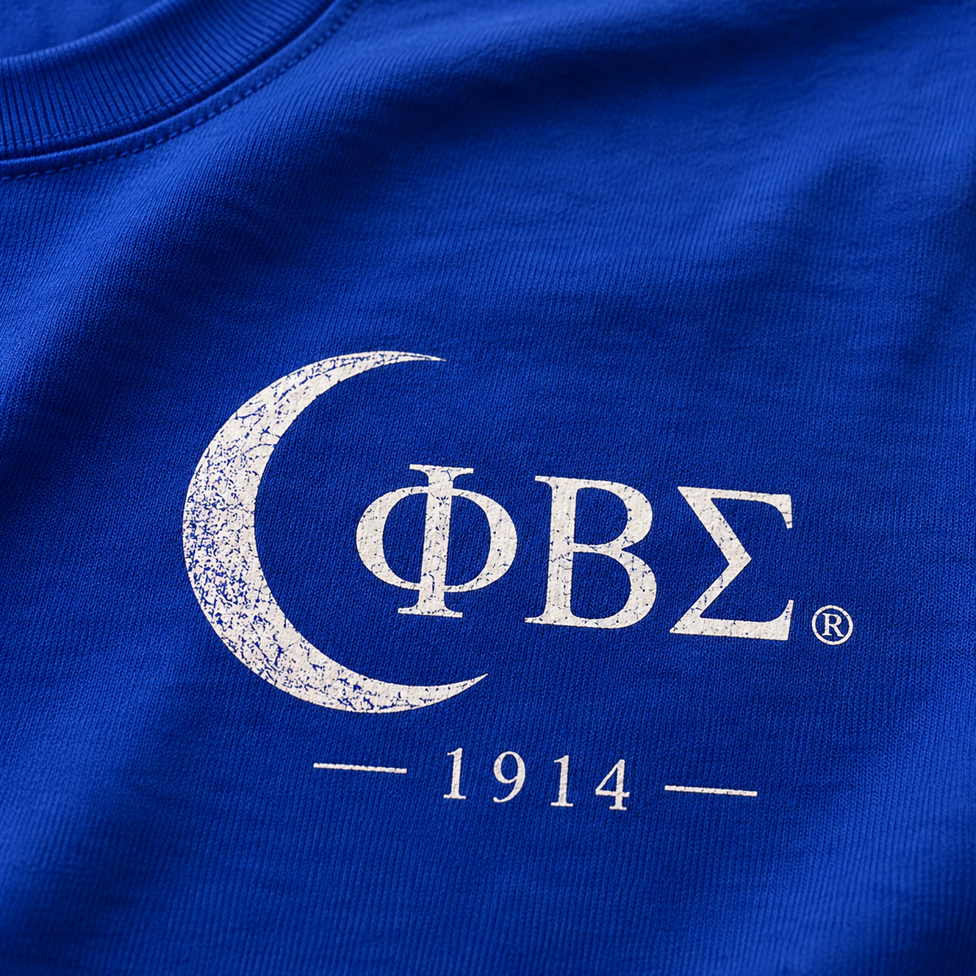 Close-up of Phi Beta Sigma Greek letters and 1914 front chest print on royal blue shirt