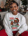 White crewneck sweatshirt with cartoon Santa graphic, raised hand, holiday text