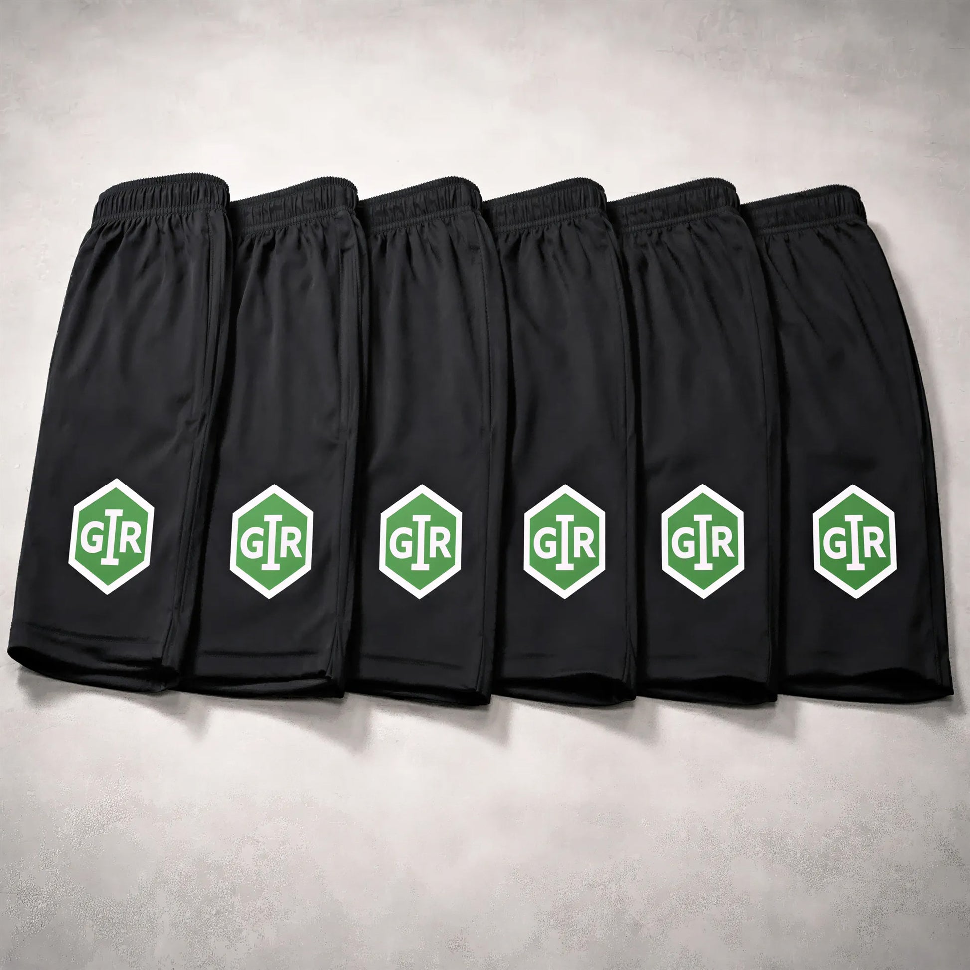 GIR Powersports black performance shorts with green logo