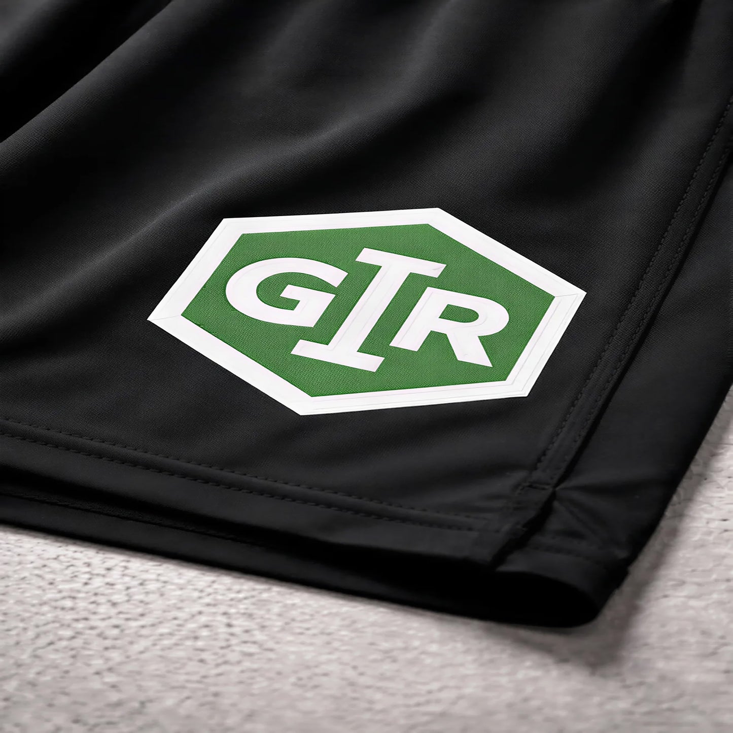 Close-up of GIR logo on performance fabric shorts