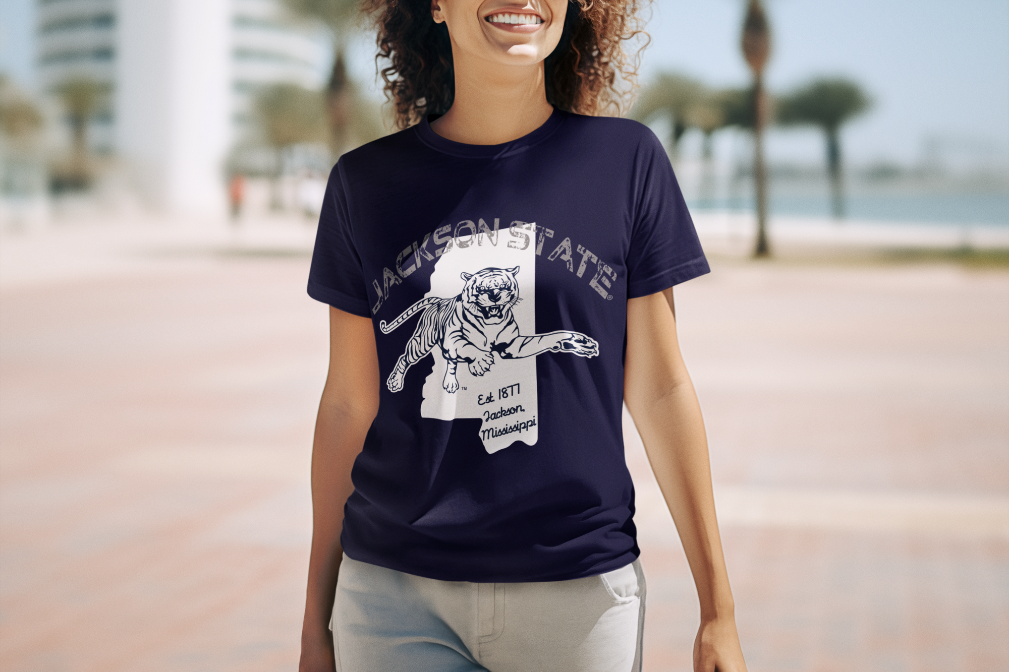 Navy short-sleeve T-shirt with front tiger logo graphic, worn by smiling woman.