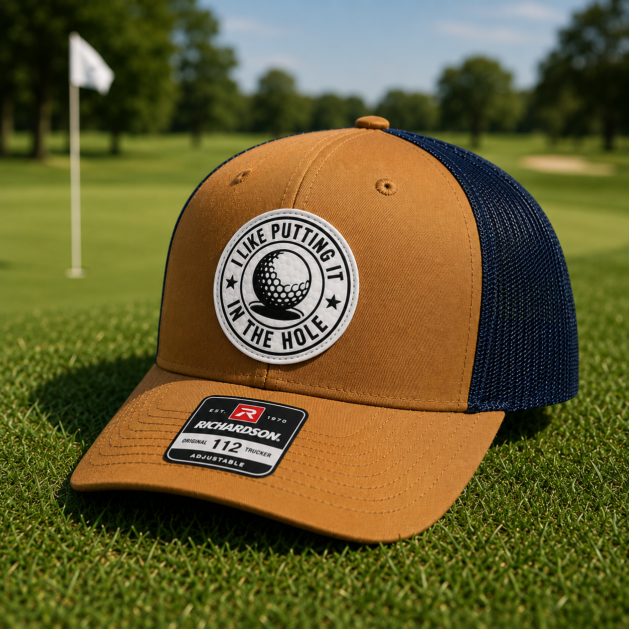 Caramel and navy trucker golf hat with brown front panel and circular 'I Like Putting' patch